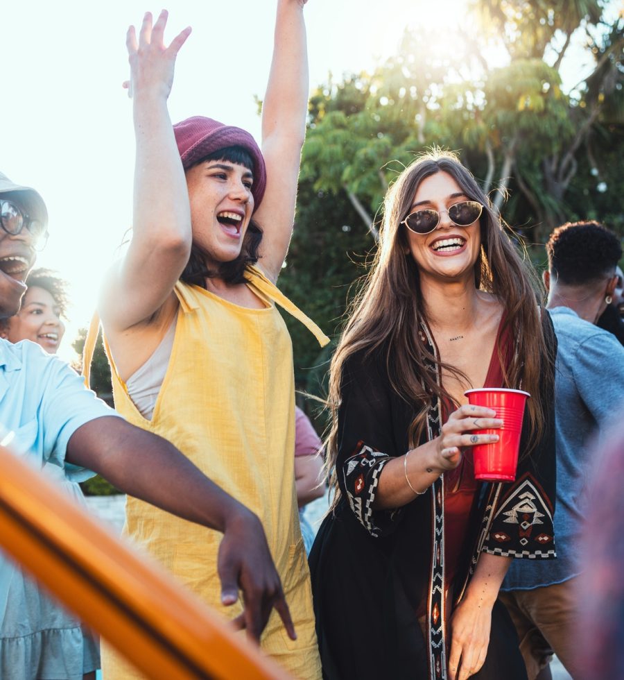 Music, drinks and friends dancing outdoor to celebrate at festival, concert or summer social event